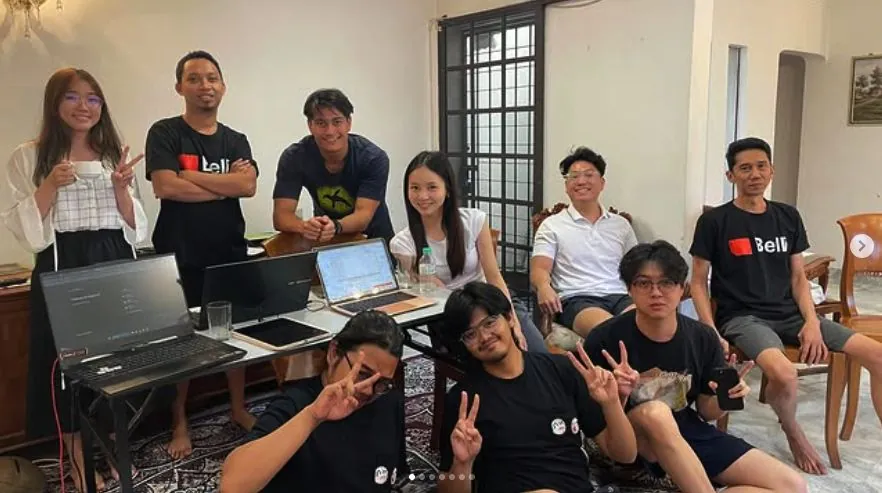 The team at a shared house with laptops, during a retreat